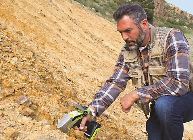Scientist using Niton XRF Analyzer for soil analysis