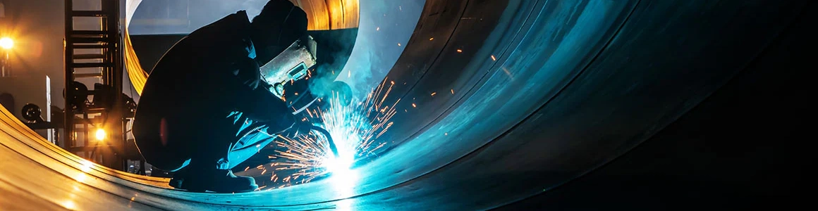 Metal fabrication worker with sparks flying