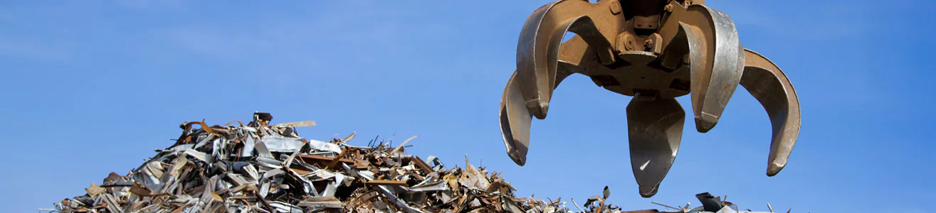 Mechanical claw grabbing scrap metal