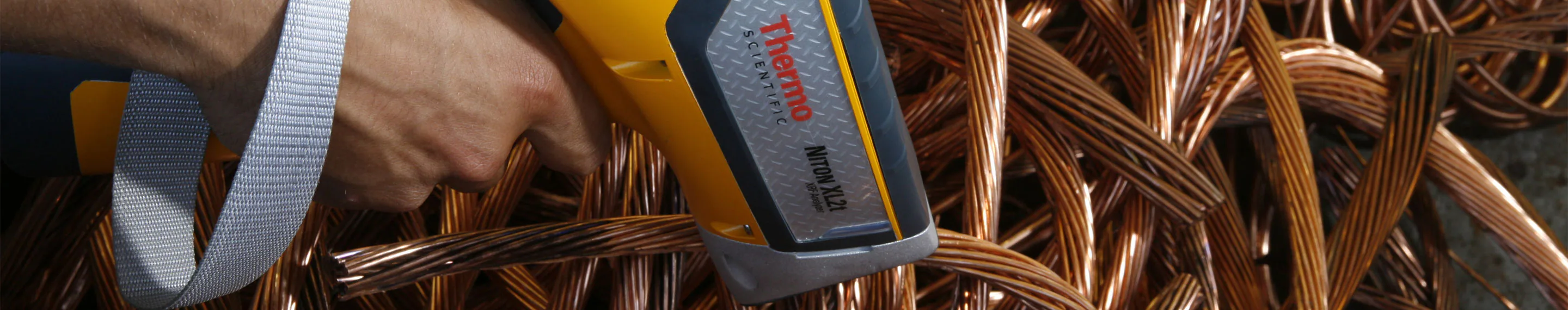 Person using Niton XRF Handheld Analyzer on scrap metals and alloys